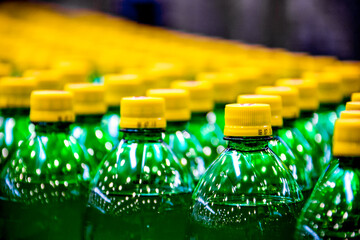 Many bottles on conveyor belt in beverage factory
