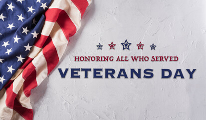 Happy Veterans day concept made from American flag and the text on white stone background.