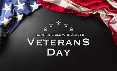 Happy Veterans day concept made from American flag and the text on dark wooden background.