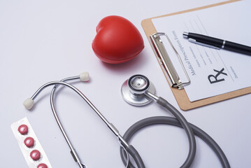 Stethoscope with heart. Stethoscope and red heart on wooden table. Hospital life insurance concept. World heart health day idea. Medicine or pharmacy concept. Empty medical form ready to be used.