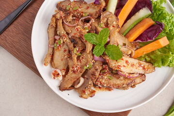 Grilled pork salad thai food with herbs and spices ingredients, tradition northeast food delicious with fresh vegetables, Hot and spicy slice grilled pork menu asian food. Grilled pork with spicy dip.