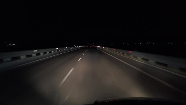 POV in the car, driving on a dark empty road, highway  in the middle of the night