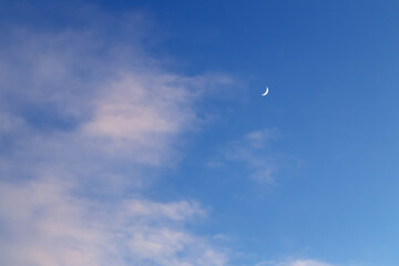 Moon on a daytime blue sky background.Place for text