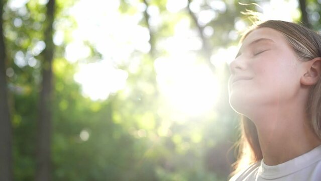 happy teenage girl closed her dream eyes in the park. teenager wants a dream portrait at sunset forest. woman daughter silhouette dream of a happy childhood. free face sister closed lifestyle eyes