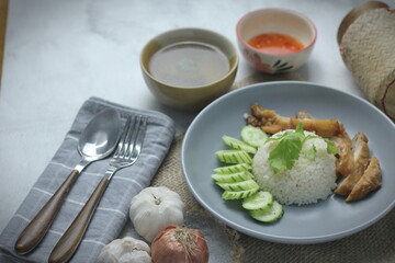 Hainanese chicken rice with fried chicken, fried chicken served with sweet dipping sauce and chicken broth, Asian style, street food commonly sold in Asia.