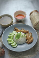 Hainanese chicken rice with fried chicken, fried chicken served with sweet dipping sauce and chicken broth, Asian style, street food commonly sold in Asia.