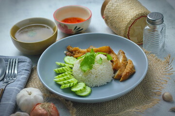 Hainanese chicken rice with fried chicken, fried chicken served with sweet dipping sauce and chicken broth, Asian style, street food commonly sold in Asia.