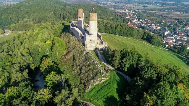 Medieval royal castle in Checiny near Kielce in Poland. Built in late 13th century. Ruin partly renovated. Aerial 4K revealing clip in sunrise light.