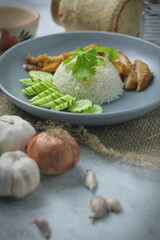 Hainanese chicken rice with fried chicken, fried chicken served with sweet dipping sauce and chicken broth, Asian style, street food commonly sold in Asia.
