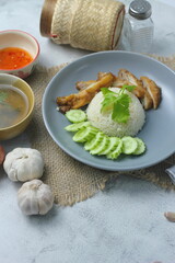Hainanese chicken rice with fried chicken, fried chicken served with sweet dipping sauce and chicken broth, Asian style, street food commonly sold in Asia.