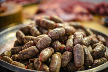 Isaan beef sausages on a tray for sale in a fresh market in Ubon Ratchathani, Thailand.