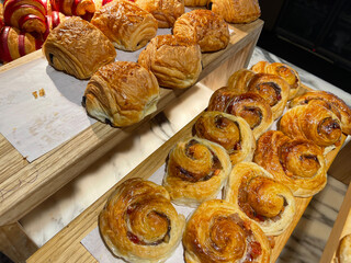 Lines of fresh baked cinamon rolls, super delicious cinamon rolls, French and American Croissants