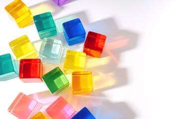 Colorful rainbow blocks on a white background. Play with light and exploring coloured shadows. Colorful toys and educational game for Kids.