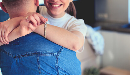 Happy couple hugging in their new house