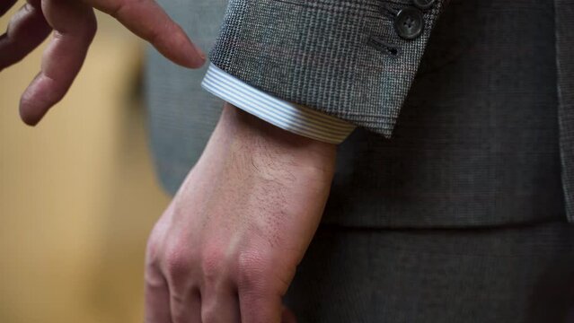 Showing correct suit jacket sleeve cuff and hem length, close up.