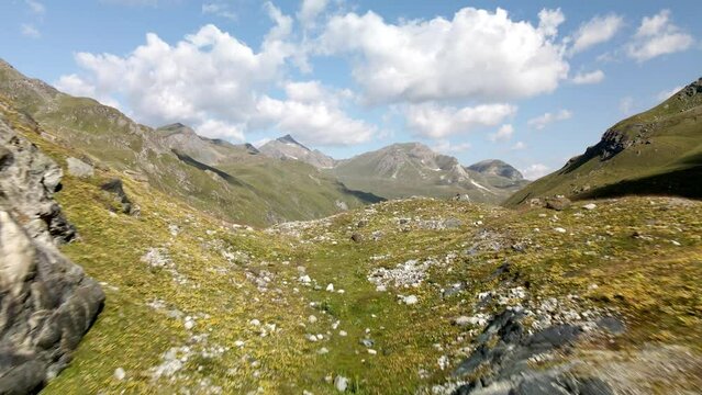 Aerial view close to the ground that reveals a big hihg mountain lake in Zinal valley, Switzerland