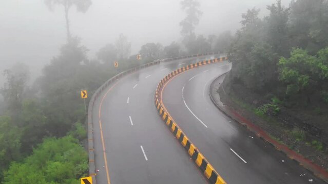 Aerial Dolly Back Over Four Lane E75 Expressway On Misty Foggy Day