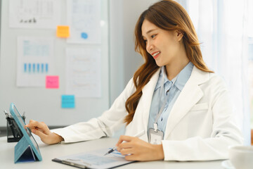 Successful business concept, Businesswoman reading financial report on tablet and taking note data