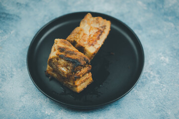 Crispy pork in black plate. Chinese or Thai roasted crispy pork, streaky pork. Thai food.