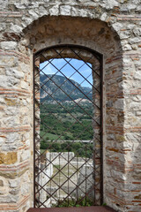 A window in the ruins of the castle of Quaglietta, a medieval village in the province of Salerno in...