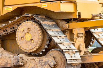 Fototapeta na wymiar Powerful crawler bulldozer close-up at the construction site. Construction equipment for moving large volumes of soil. Modern construction machine. Road building machine.