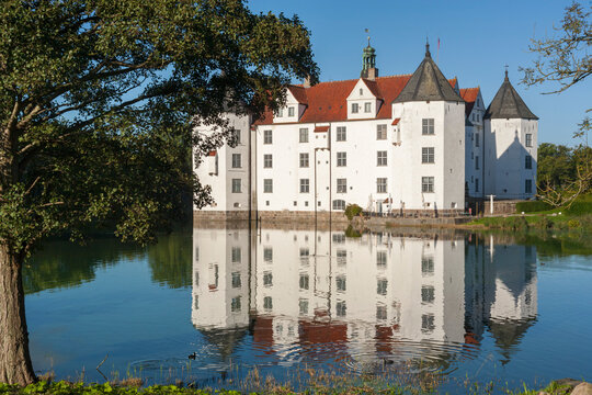 Water castle at Glücksburg, Germany, reflected in itsmoat
