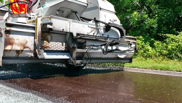Heavy Machinery Resurfacing a Road Using Micro Asphalt Dressing