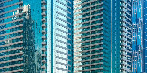 Glass facade of modern office building in Dubai