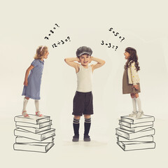 Group of little children, boy and girls playing together, Girls standing on drawn books and...