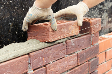 Construction of a brick wall. Brick laying. selective focus