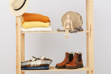 Wooden shelving with clothes, autumn season clothes