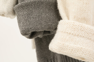 Hanging sweaters, concept of autumn season clothes