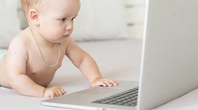 A baby and a computer, head shot laptop