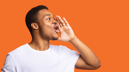 Side View Of Black Man Shouting Posing On Orange Background