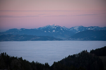 Fototapeta na wymiar sunset in the mountains, beautiful view calming sea of fog and forest silhouette