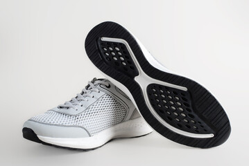 Advertising of sports shoes, summer sneakers. Front view and view of sole of light-colored light...