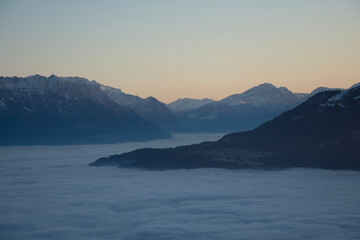 beautiful mountain view at sunset and calming sea of fog