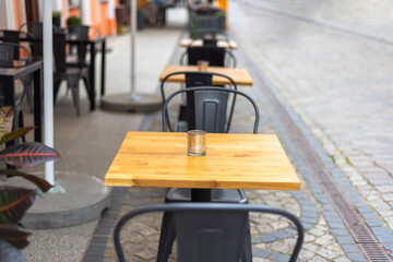 Close up shot of empty cafeteria or restaurant tables with chairs on the street