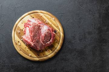 Raw beef meat on a wooden cutting board