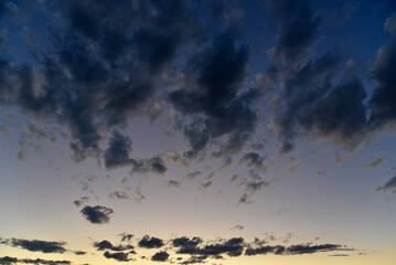 Silvery clouds in the blue sky in the evening. Beautiful blue clouds on a summer evening.