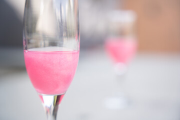 glass of pink champagne at bar