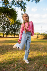 Portrait of a European girl with freckles. Beautiful child smiles. Portrait of a teenage girl. Happy girl jumping. The girl makes faces