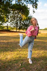 Portrait of a European girl with freckles. Beautiful child smiles. Portrait of a teenage girl. Happy girl jumping. The girl makes faces