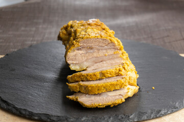 baked bacon cut into slices on a dark plate. food concept.