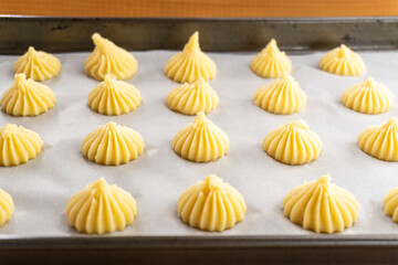 raw eclairs on a baking sheet. food concept. dessert