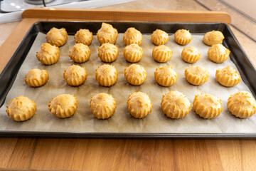 profiteroles on a baking sheet. food concept. dessert