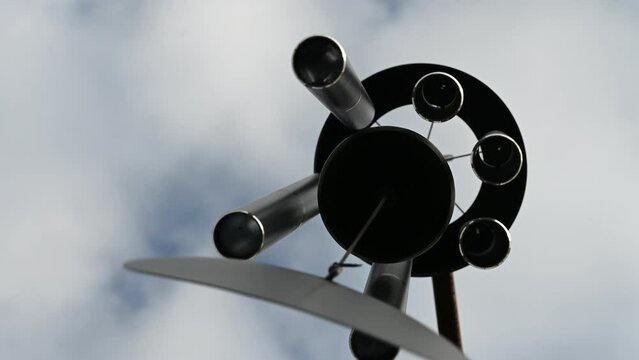 Looking up to the sky underneath a spinning wind chime.