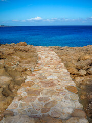 stone road to the cliff beach