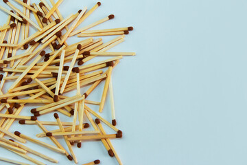 yellow wooden matches with brown sulfur heads on a blue background