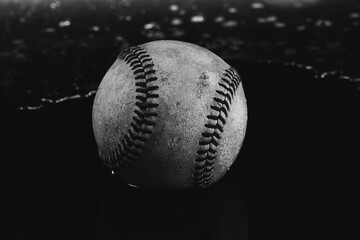 Old used texture of baseball ball in water close up for rain game concept in sport.